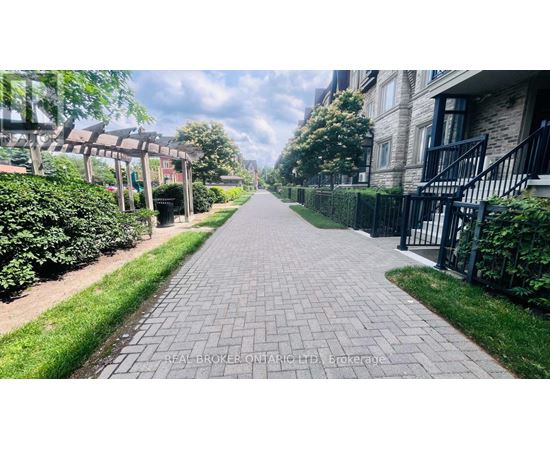A long brick pathway leads through a residential area.