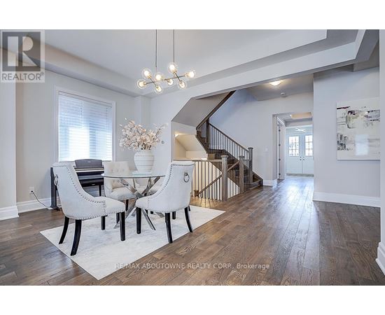 A dining room with a white table and chairs.