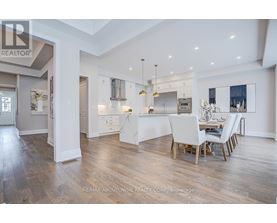 A spacious kitchen with a dining table set for four.