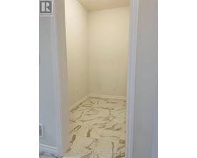 A room with a marble floor and white walls.