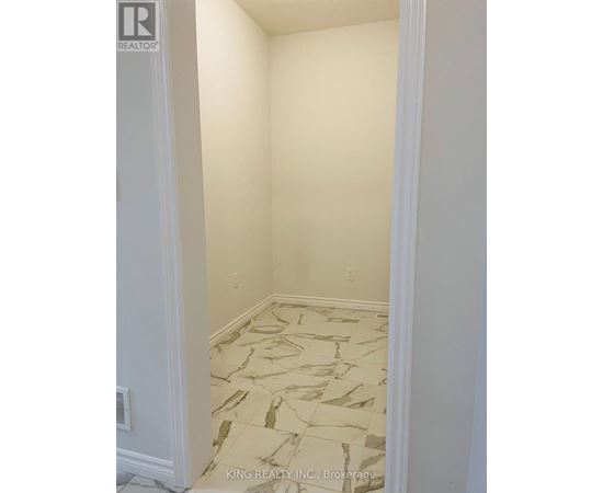 A room with a marble floor and white walls.