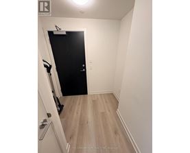 A hallway with a black door and a white door with a silver handle.