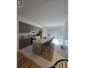 A kitchen with a center island and bar stools.