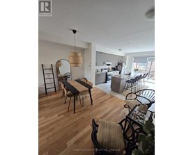A dining room with a wooden table and chairs.