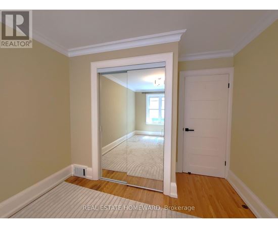 A room with a mirror door leading to another room.