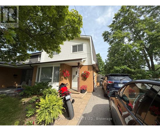A house with a motorcycle parked in front of it.