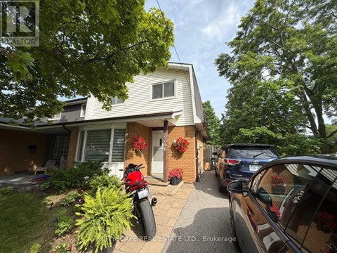A house with a motorcycle parked in front of it.