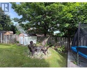 A backyard with a table and chairs and a hot tub.
