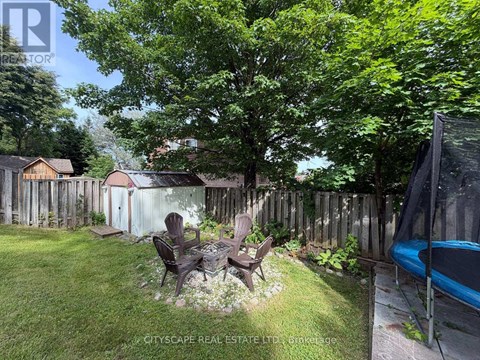 A backyard with a table and chairs and a hot tub.