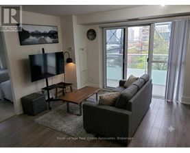 A living room with a couch, a coffee table, and a television.