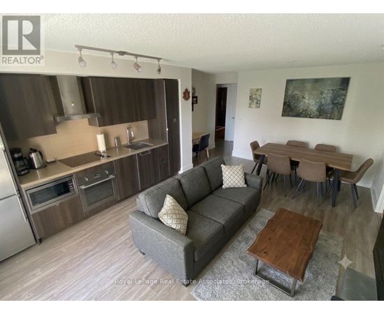 A living room with a grey couch and a wooden coffee table.