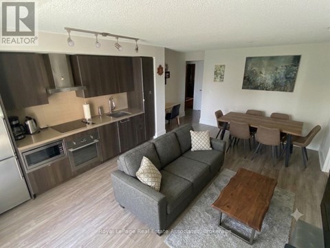 A living room with a grey couch and a wooden coffee table.