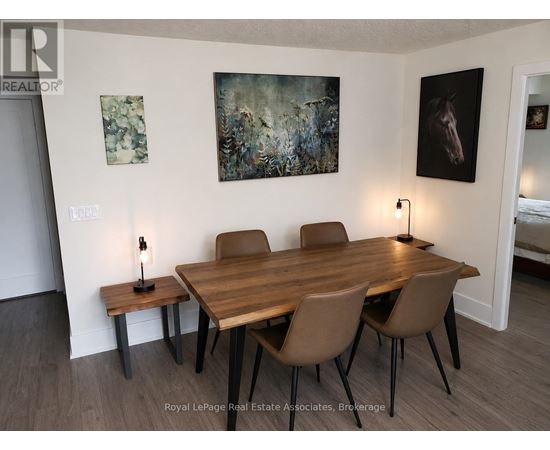 A dining room with a wooden table and chairs.