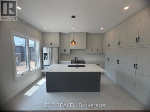 A modern kitchen with white cabinets and a large island.