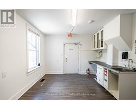 A kitchen with white cabinets and a black countertop is shown.