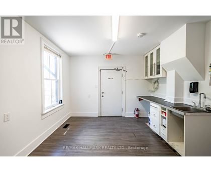 A kitchen with white cabinets and a black countertop is shown.
