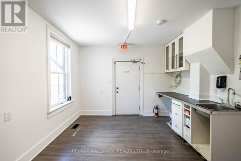 A kitchen with white cabinets and a black countertop is shown.