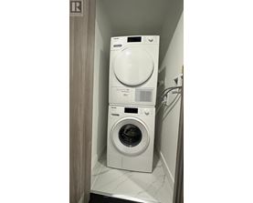 A white dryer and washer in a small laundry room.