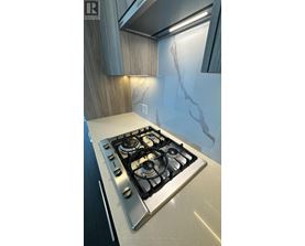 A modern kitchen with a stove top oven.