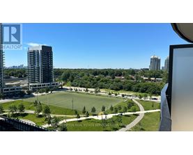 A view from a high-rise building looking down at a green park area.