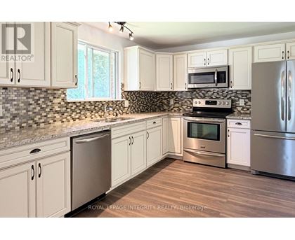 A kitchen with white cabinets and stainless steel appliances.