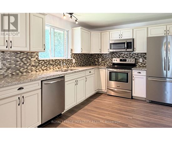 A kitchen with white cabinets and stainless steel appliances.
