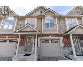 A house with a grey front door and two garages.