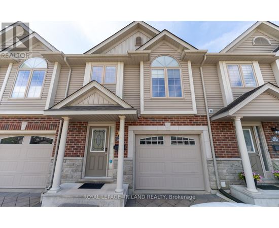 A house with a grey front door and two garages.