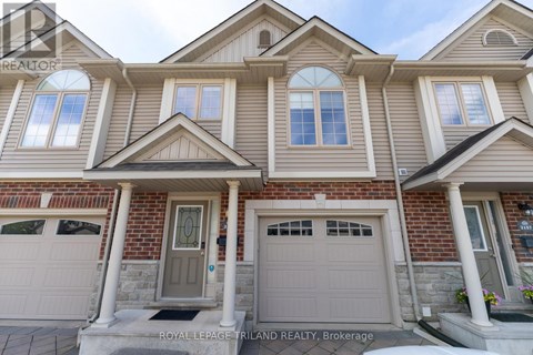 A house with a grey front door and two garages.