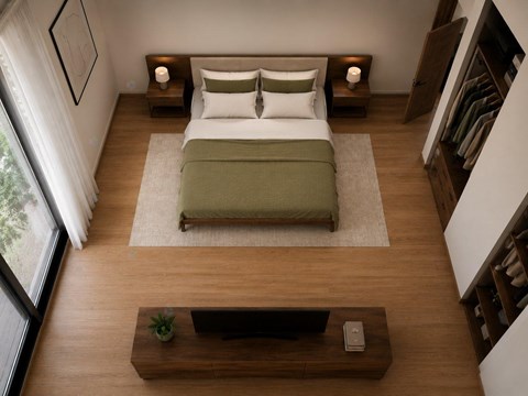 A bedroom with a bed, nightstands, and a window.