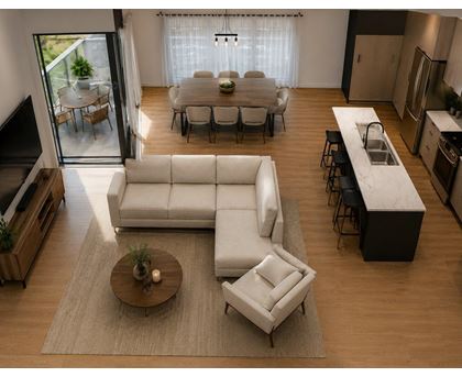 A modern living room with a white sofa and a coffee table.