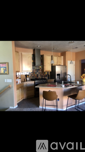 A kitchen with a black stove top oven and a black refrigerator.