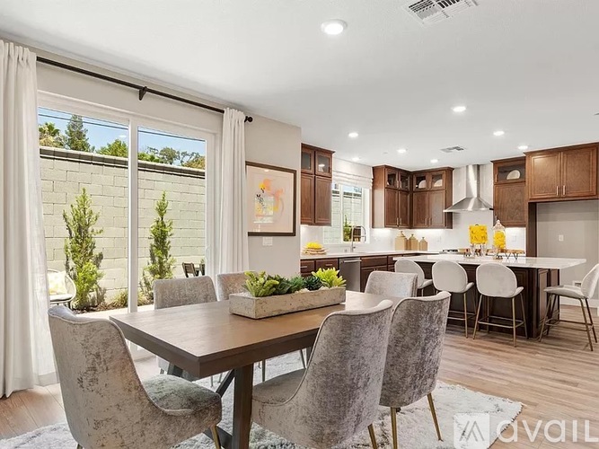A modern dining room with a large table and chairs.