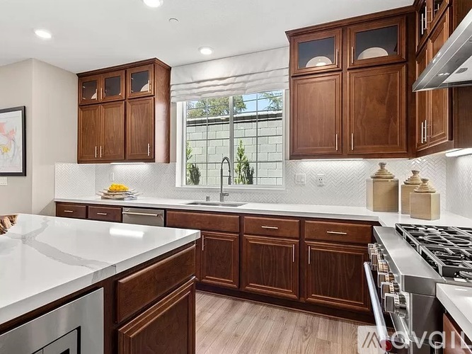 A kitchen with wooden cabinets and a white countertop.