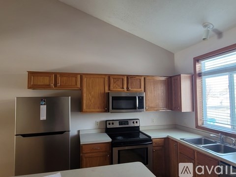 A kitchen with wooden cabinets and stainless steel appliances.
