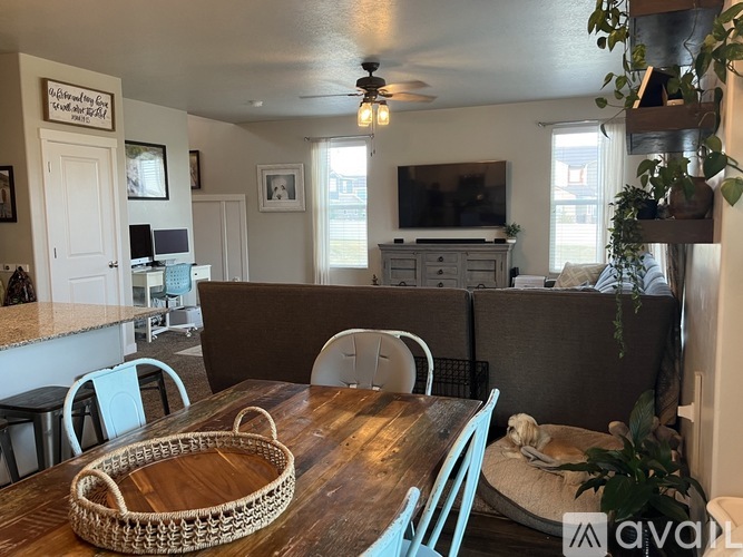 A dining room with a wooden table and chairs.