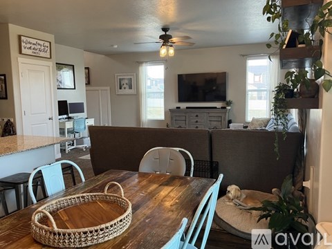A dining room with a wooden table and chairs.