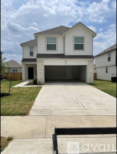 A two-story house with a garage is for sale.