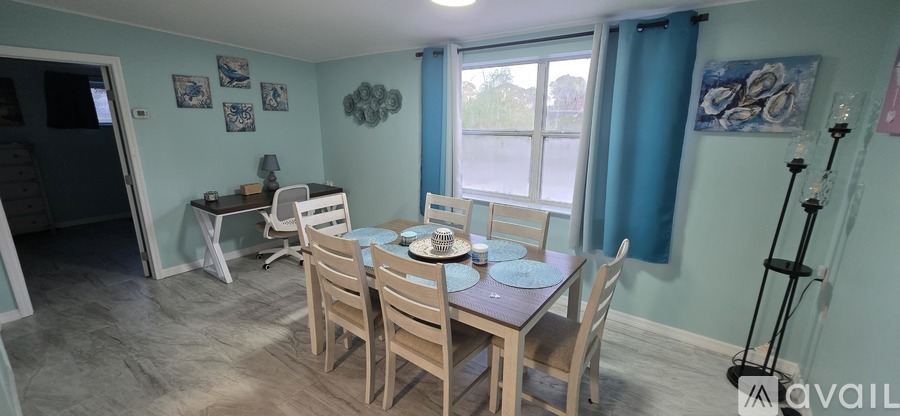 A dining room with a table set for four.