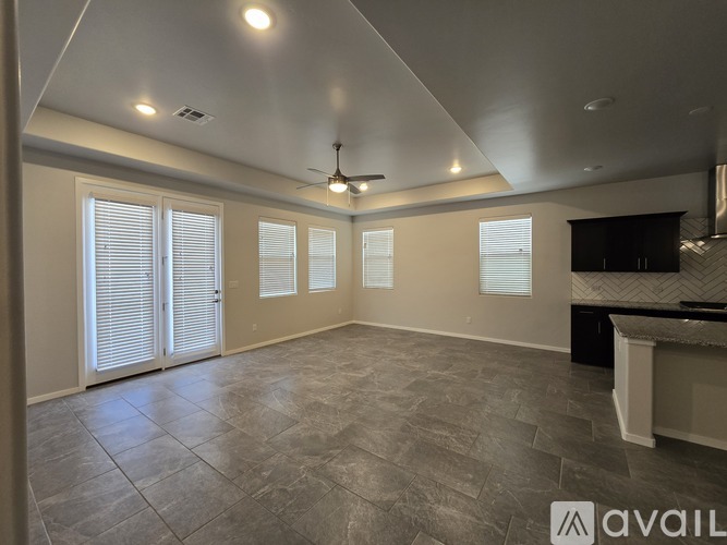 A spacious room with a fan and a counter.