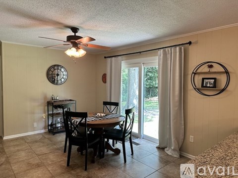 A dining room with a table set for four.
