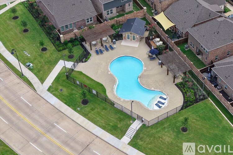 A backyard with a pool and a deck.
