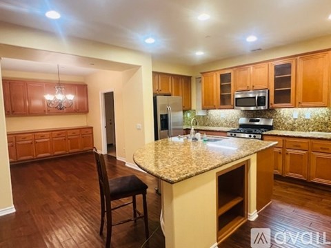 A kitchen with wooden cabinets and a granite countertop.