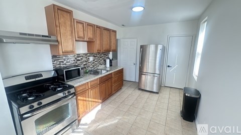 A kitchen with a stove, microwave, and refrigerator.