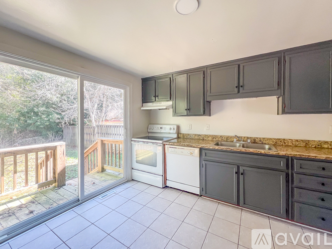 A kitchen with a white oven and black cabinets.
