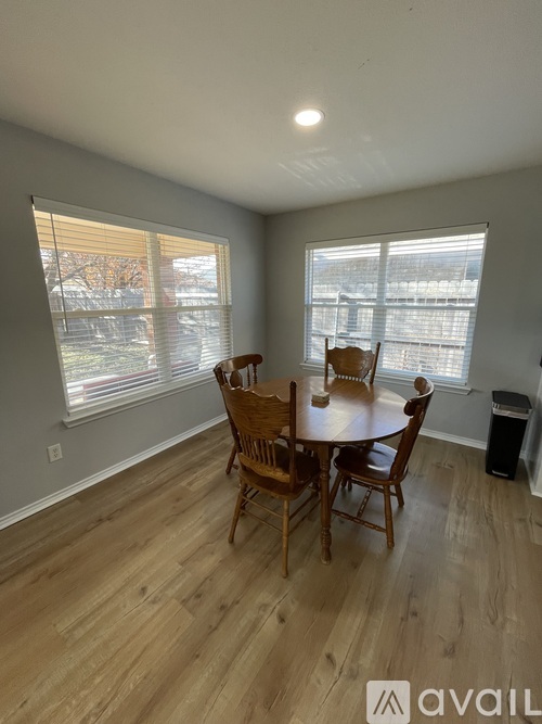 A dining room with a table and chairs.