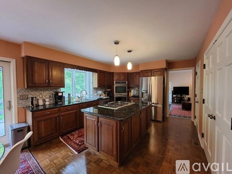 A kitchen with wooden cabinets and a granite countertop.