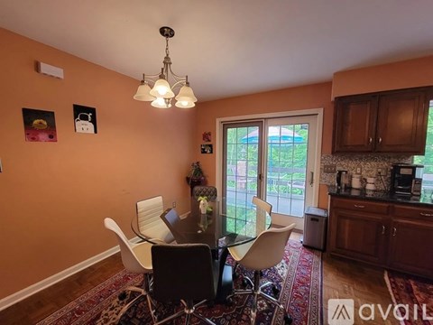 A dining room with a table and chairs.