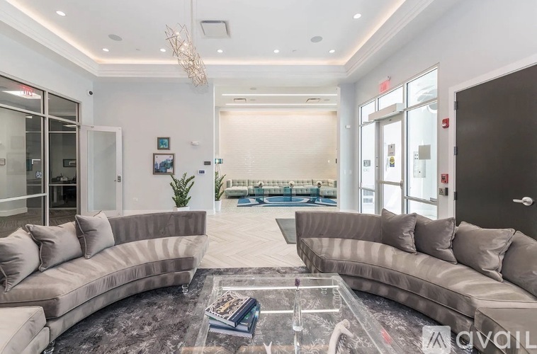 A spacious living room with a large sectional sofa and a glass coffee table.