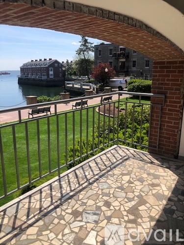A view from a balcony looking out at a body of water and buildings.